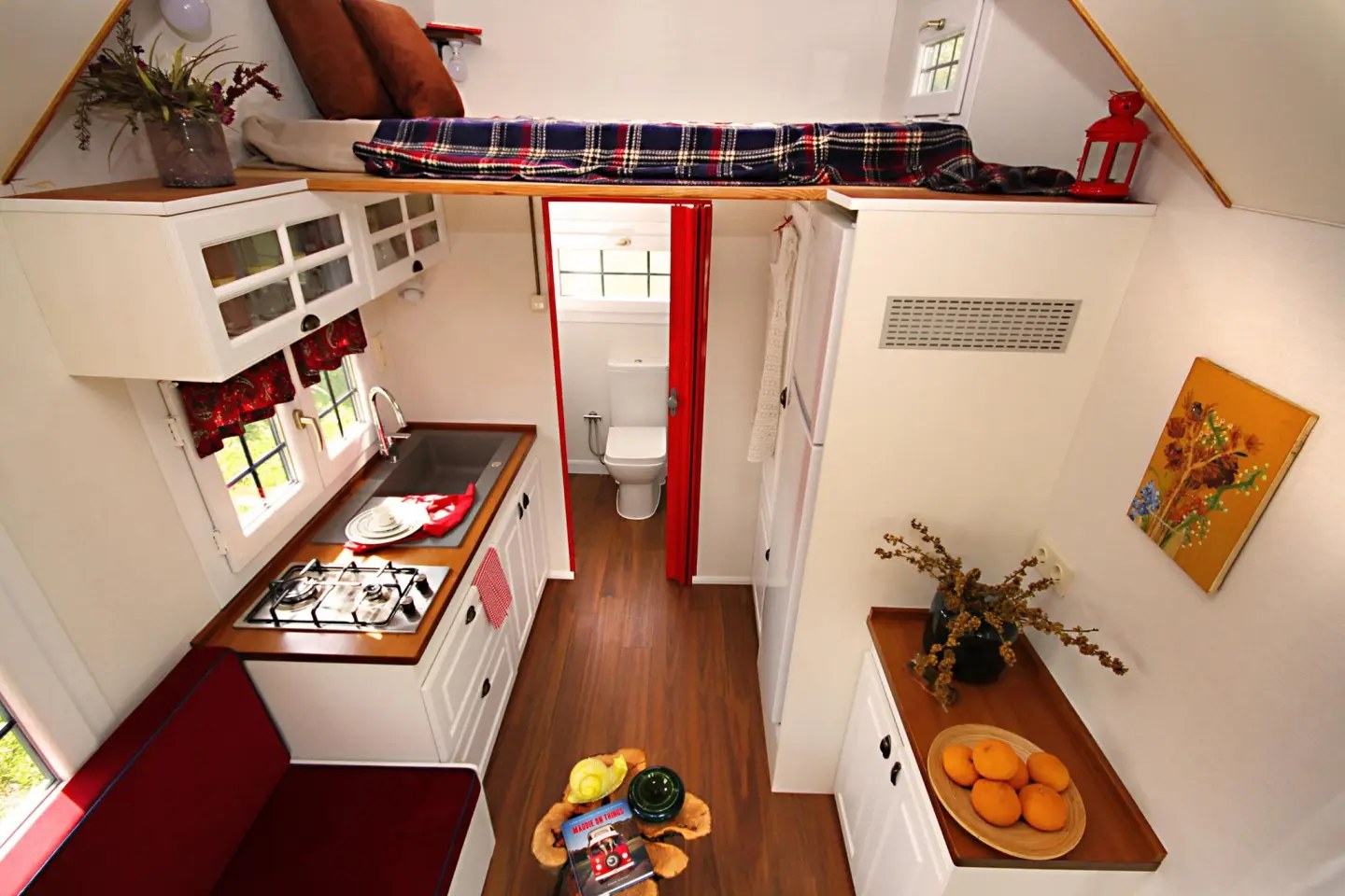 The Sunrise Tiny House's bedroom is located in a loft above the kitchen and bathroom